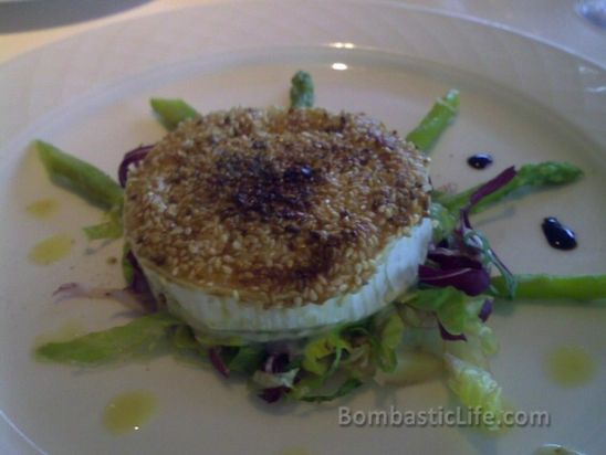 Caprino con Asparagi—warm goat cheese coated in sesame seeds served with grilled asparagus, oil and lemon dressing on a mixed leaves salad at Signor Sassi in Kuwait.