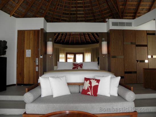 Seating area and bedroom of an over the water villas at W Hotel and Resort in the Maldives.