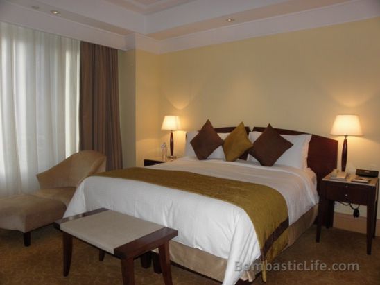 Bedroom of a Fullerton Suite at Fullerton Hotel in Singapore.
