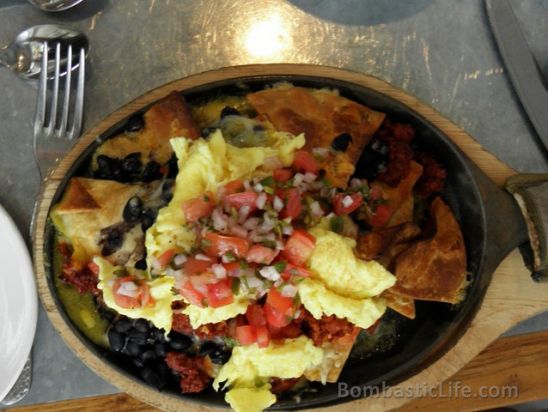 Chilaquiles – Scrambled eggs, housemade chorizo, black beans, cheddar cheese, salsa verde and Pico de  Gallo.