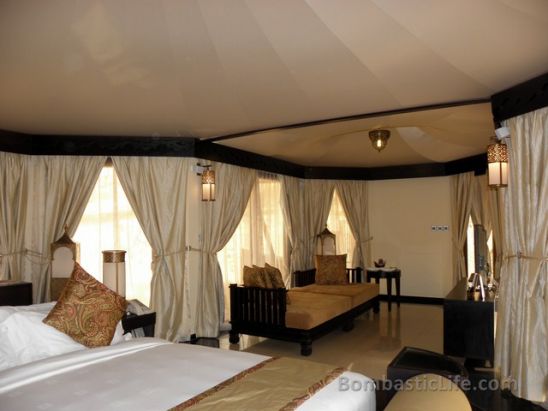 Bedroom and Living Room of an Al Sahari Tented Pool King Villa at Banyan Tree Al Wadi in Ras Al Khaimah.