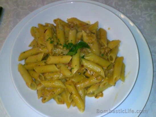 Spicy penne pasta with chicken in a pink sauce at Viaggio Italian Restaurant in Kuwait.