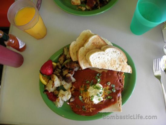 Tamales and Eggs – Two pork tamales and two eggs topped with Mexican gravy served with griddle potatoes and toast

