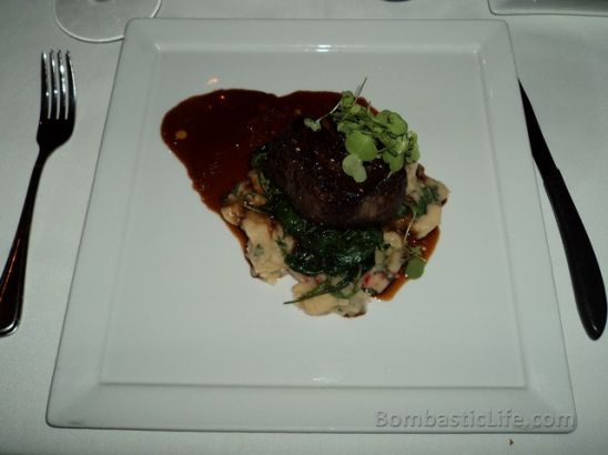 Filet mignon with cippolini and chanterelle red wine sauce, braised lima beans with lemon and sauteed watercress at Bice Italian Restaurant in Montreal.