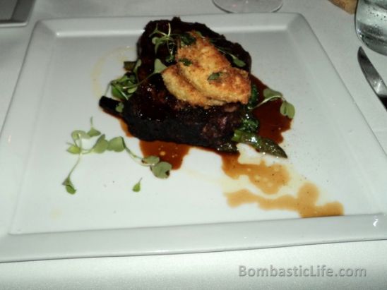 Spice crusted Angus rib steak with breaded pan-fried heirloom tomato, marinated broccilini and asparagus at Bice Italian Restaurant in Montreal.