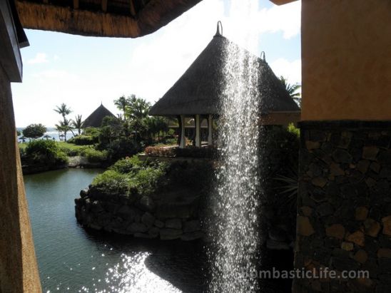 Waterfall at the entrance falling into the pond at The Oberoi Mauritius.