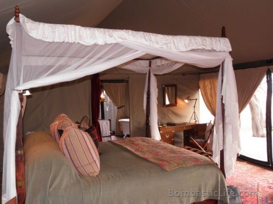 Bed of a luxury tent at Singita Sabora Tented Camp - Grumeti Reserves, Tanzania.