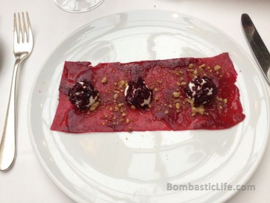 Roasted beet carpaccio with goat cheese mousse and blackberry pearl, fennel cress, walnut dust and maple glaze